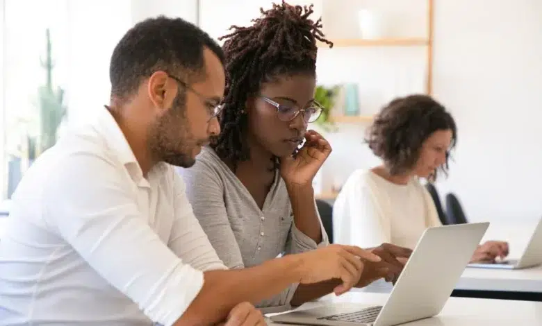 Instructor explaining corporate software specific to intern