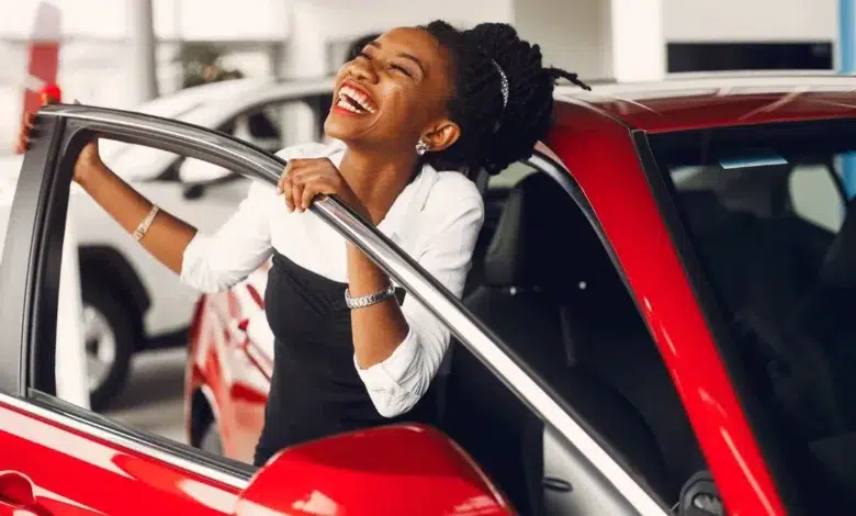 Stylish black woman in a car salon (1)