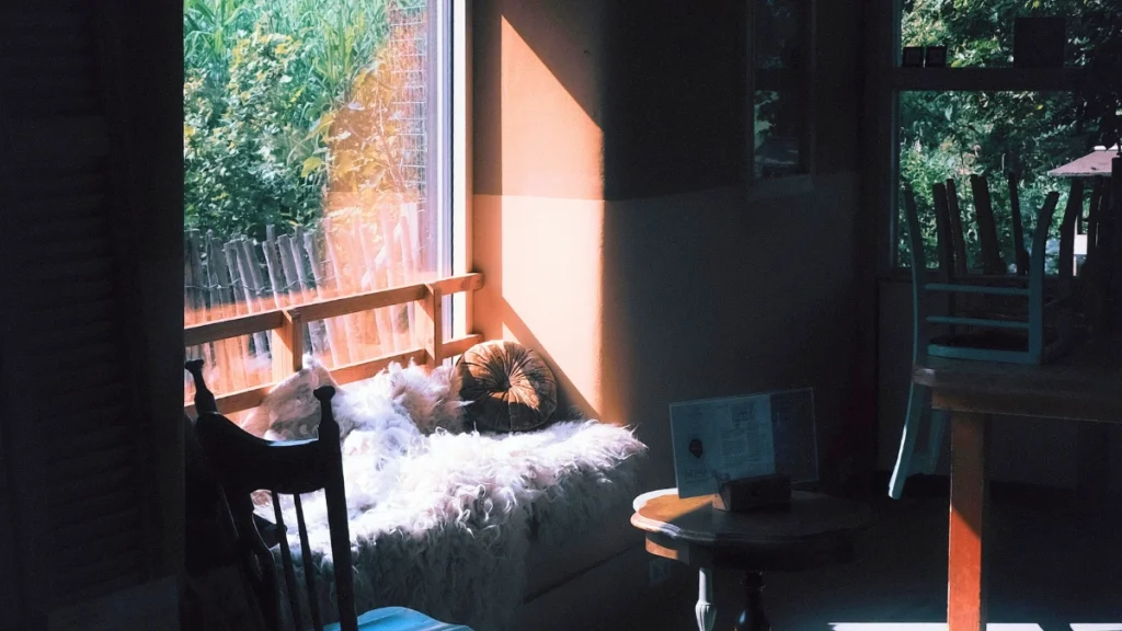 Cozy Sunlit Nook with Window Seat and Chairs